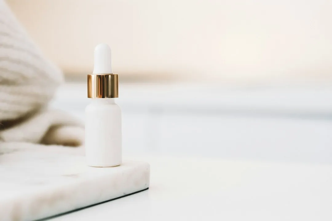 Skincare dropper bottle arranged on a light surface